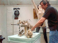  The first of the clay is added to the armature, starting with the back.